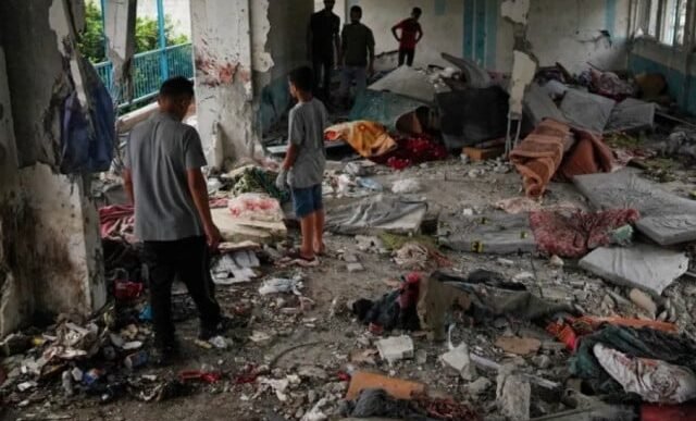 palestinians check the damage at the un run school that was hit by an israeli air attack in nuseirat photo afp