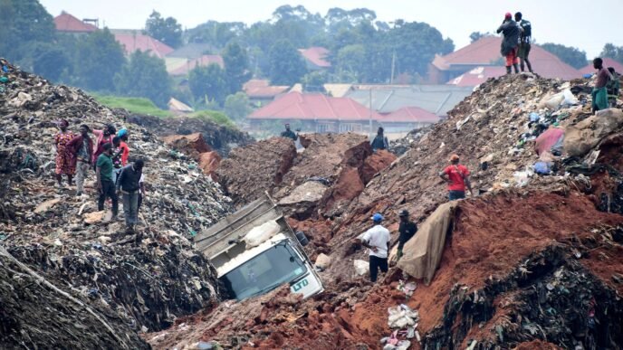 people gather as volunteers search to retrieve the bodies of residents killed by a landslide due to heavy rainfall in a landfill known as kiteezi that serves as garbage dumping site in the lusanja village outside kampala uganda on august 10 2024 photo reuters