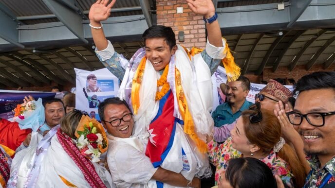 A record-setting teen climber returns home to Nepal to a hero's welcome