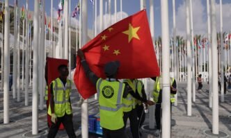 Workers get ready to hoist the national flag of China at the venue of the UNFCCC COP28 Climate Conference on November 29, 2023, the day before its official opening in Dubai, United Arab Emirates. COP28 is bringing together stakeholders, including international heads of state and other leaders, scientists, environmentalists, activists and others to discuss and agree on the implementation of global measures toward mitigating the effects of climate change. (See story on Page 4) Photo: VCG