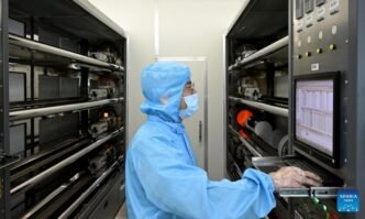 A staff member of Anhui North Microelectronics Research Institute Group Corporation Limited works on the production line of MEMS wafers in the China Sensor Valley at Bengbu City, east China