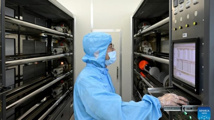 A staff member of Anhui North Microelectronics Research Institute Group Corporation Limited works on the production line of MEMS wafers in the China Sensor Valley at Bengbu City, east China