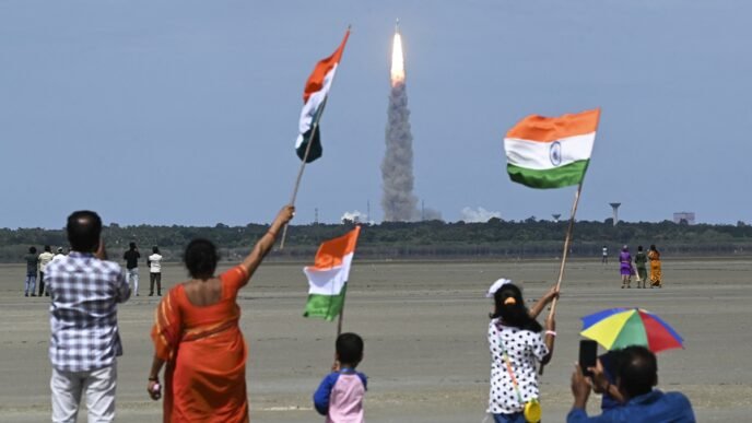 People wave Indian flags as an Indian Space Research Organisation (ISRO) rocket carrying the Chandrayaan-3 spacecraft lifts off from the Satish Dhawan Space Centre in Sriharikota, an island off the coast of southern Andhra Pradesh state on July 14, 2023. Photo: AFP