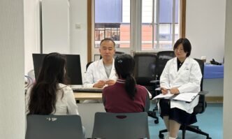 Ma Xiquan and his coworker conduct a medical consultation at the Shanghai Children