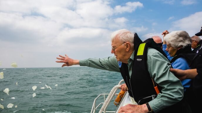 A relative of British POWs pays tribute at the site where the Lisbon Maru sank in 1942, in October 2019. Photo: Courtesy of the production team