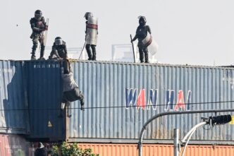 Pakistan security forces accused of pushing ‘praying’ protester off 25ft-tall container tower