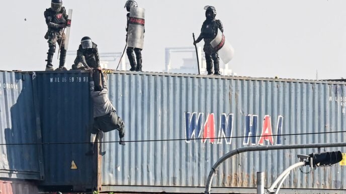 Pakistan security forces accused of pushing ‘praying’ protester off 25ft-tall container tower