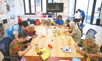 Elderly residents participate in a craft-making session at a local nursing home