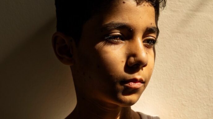 Portrait of Palestinian boy who lost both arms in Israeli strike named press photo of the year