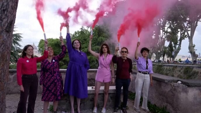 Activists use pink smoke to call for more women in the Catholic church