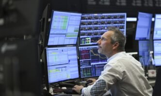 A trader watches monitors on the trading floor of the Frankfurt Stock Exchange on April 10, 2025. Photo: VCG