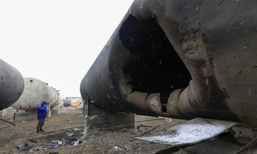 A worker inspects the damage at the AES Group private oil refinery the day after a Russian shock drone attack, in Merefa, Kharkiv region, Ukraine, on March 18, 2025. It marks the fourth attack on the enterprise since February 2022, the AES Group officials said. Photo: VCG