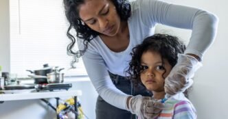 As part of her daily routine, Deysi Vargas runs a saline solution through her daughter's intravenous line before her morning shower and school.