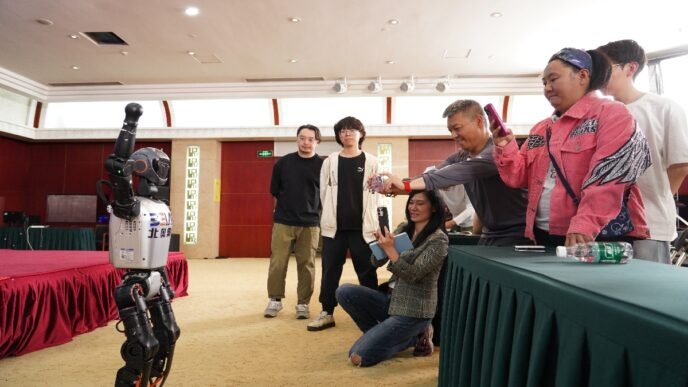 A humanoid robot interacts with the media at a press conference unveiling the 2025 World Humanoid Robot Sports Games. Photo: VCG
