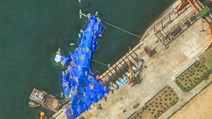 North Korea pulls capsized warship upright after botched launch, report says